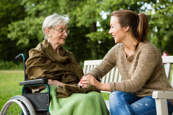 grandmother and granddaughter sitting outside